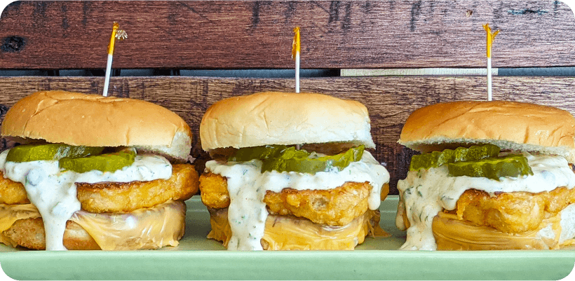 A plate of three fried fish sliders